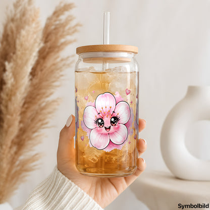 Zarte Blüten mit Gesicht als UV-DTF Sticker auf einem 16oz Glasbecher
