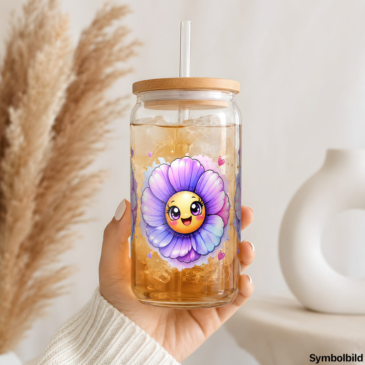 Blaue Blüten mit Gesicht als UV-DTF Sticker auf einem 16oz Glasbecher